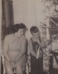 With his mother at the Christmas tree, 1960s
