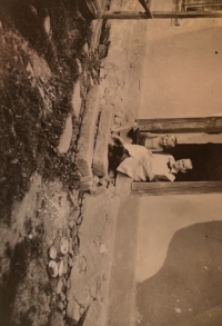 Little Břetislav Trakal with his grandmother in front of their house