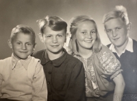 Witness and her brother (right) with two war-stricken boys (left) whom the witness's parents fostered for some time