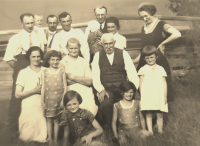 A sepia version of the photograph of the whole family with subdued contrast - the photograph from the archive of the witness is coloured and the eyes of the girl in the polka-dotted dress on the left (Zdena Šimková) did not benefit from it. Would it be better this way?