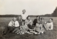 With her parents. Eva Rajmonová (nee Cihlářová) second from the left in the first row, her sister Milena Cihlářová is fourth from the left in the second row, their father Ladislav Cihlář is first from the right in the second row, 2nd half of the 1940s