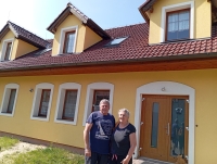 František Nestával with his wife Marcela during recording in 2025 in front of the reconstructed farmhouse