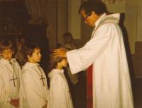 Priest Blaze during the baptism of witness' son Tomáš
