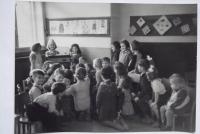 With children in kindergarten (at the back, looking into the camera)