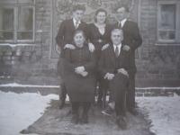 Bohumil Filípek with his family, parents are sitting on the chairs