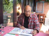 Milan Ressel with a book of his comics
