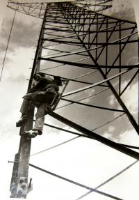 Robert Ospald climbing up the transmission tower