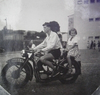 Riding a motorbike with his sister in late 1940s.