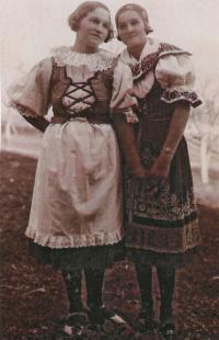 B. Dardova in a traditional old dress (right)