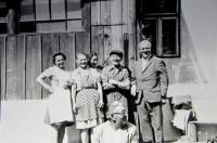 In front of the Škrabánek family house in the pasturage settlement V Háji. On the right the resistance fighter Karel Žalský with Miroslav's parents, sisters and brother.