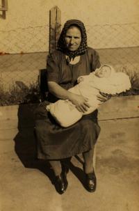 Granny of Stefan´s wife, Katerina, holding her as a baby in her arms, Slovakia, 1953 