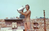 Pavel Douša drinking beer from a flask during construction work on his house, 1983