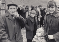 early 1970s; in front of the church in Záběhlice; Bonaventura Bouše, his mother, and his brother Jakub; his father is seen talking to Antonín Hartmann in the background