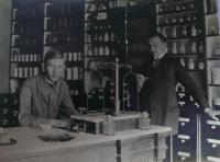 Václav Moravec Sr. sitting in the pharmacy in Čáslav, about 1925