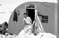 Josef Svoboda cleans snow away in front of a field research dormitory / Canada / 1970