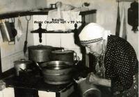 28 - 99-year-old grandmother cooking in the kitchen
