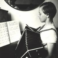 Playing the accordion as a young girl