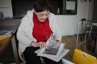 Jarmila Sikytová in 2018, showing photos of restored artworks