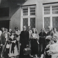 Josef Jančář with young people across the street from the St. Maurice church in Olomouc, the first church where he served as a priest at the post of second chaplain