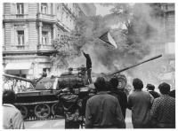 Burning tank 212 and a young man with a flag, 21 August 1968
