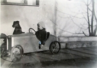 Mr. Grulich as a kid - driving a toy car